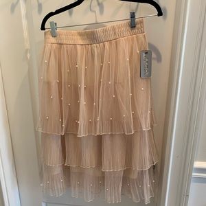 mid-length pink skirt with pearl accents